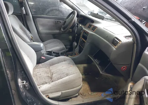 1997 Toyota Camry Le z USA, uszkodzony, nr VIN JT2BG22K5V0021599